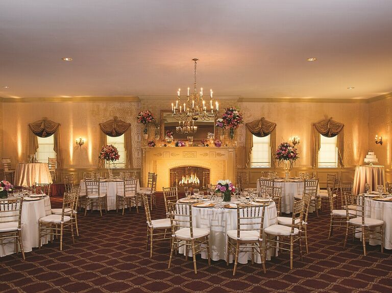Grand reception space with fireplace and gold Chivari chairs