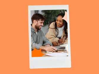 Coworkers together in front of a laptop