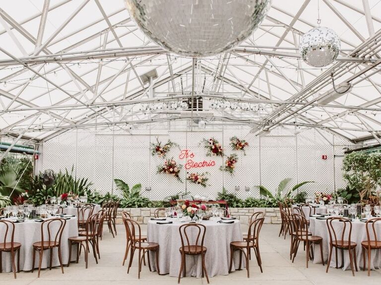 Greenhouse wedding with disco balls and neon sign