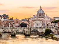 Rome skyline at sunset with Tiber river and St. Peter's Basilica, Italy 