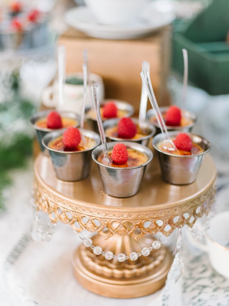 Individual portions of creme brulee arranged on a cake stand. 
