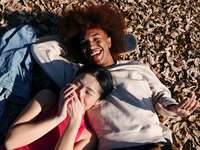 Couple laying down on the ground and laughing