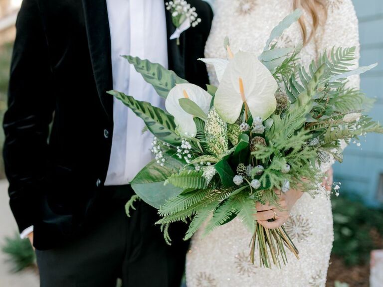 tropical greenery wedding bouquet with ferns, white anthuriums and banana leaves