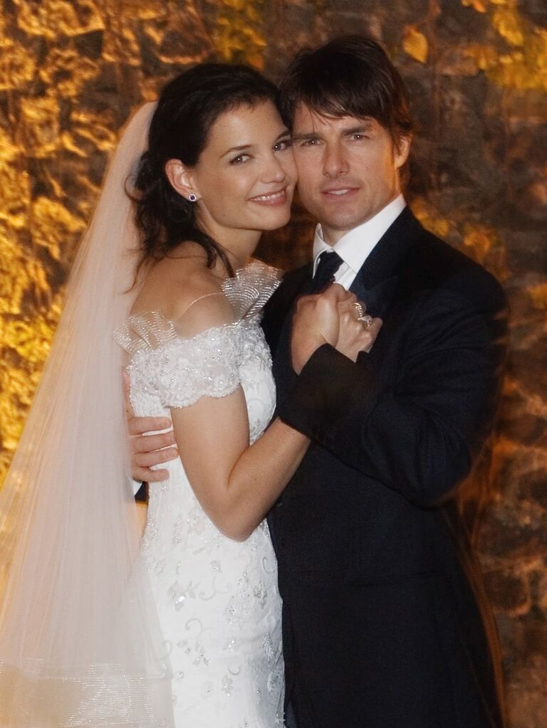Tom Cruise and Katie Holmes posing together on their wedding day