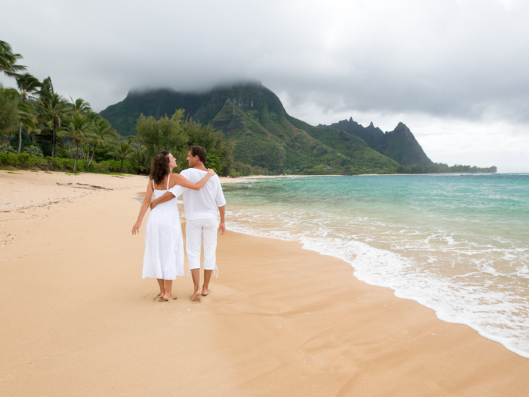 Couple walking on beach in Hawaii 
