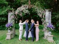 Grooms wearing traditional Greek Stefana crowns during wedding unity ceremony