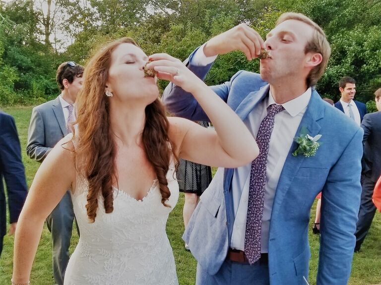 Happy married couple eating oysters