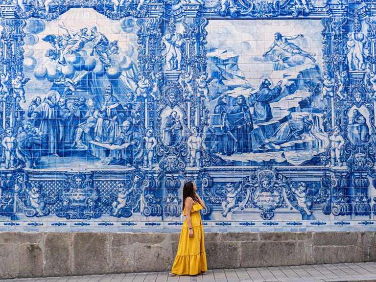 Chapel of Souls in Porto with a person in a vibrant sundress