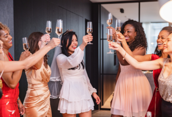 Bride and friends having celebratory toast at bridal shower