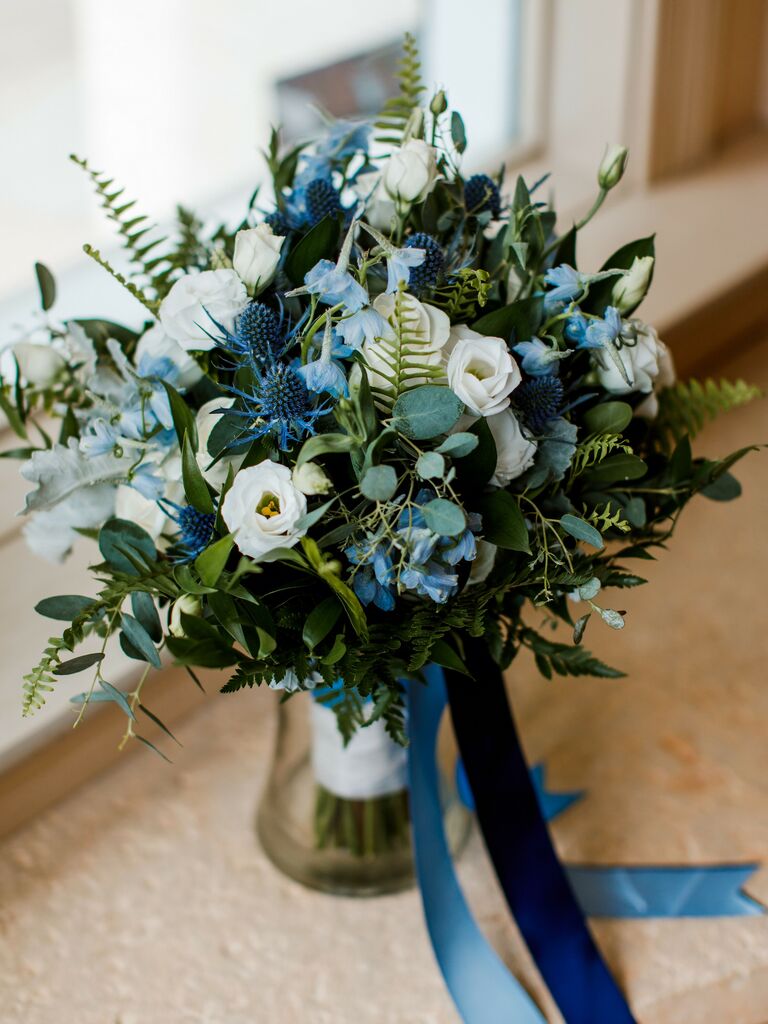 blue wedding bouquet with thistle, delphinium, white lisianthus and greenery