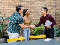 Couple shaking hands with wedding planner
