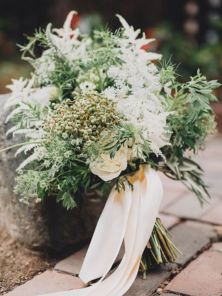 greenery wedding bouquet with white astilbe, white roses, thistle and white ribbons