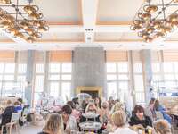women enjoying lunch sitting at tables at bridal shower